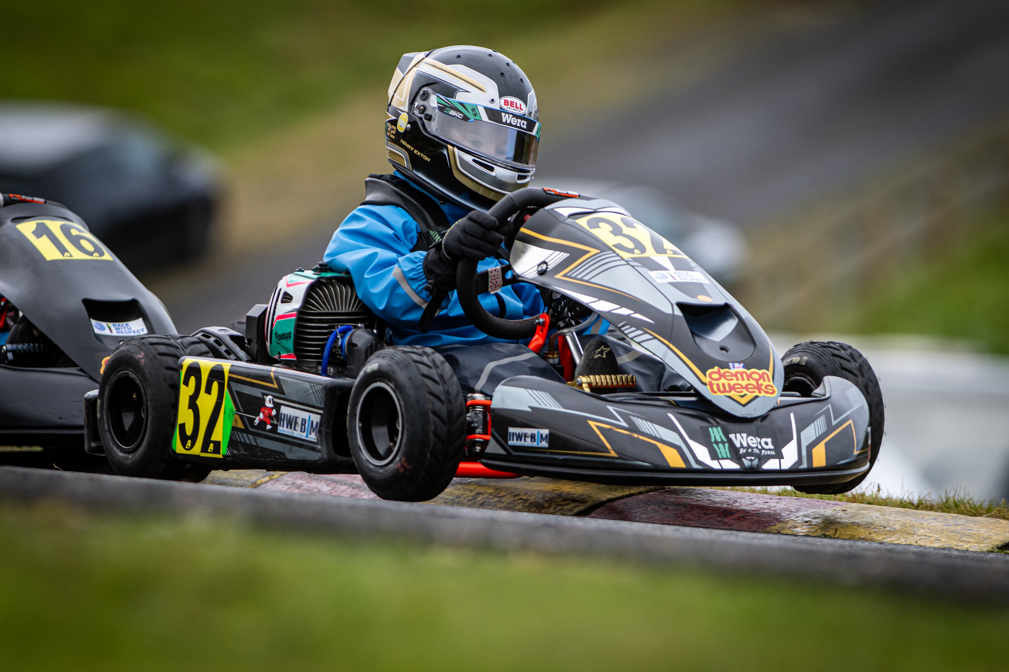 Henry Exton kart number 32 cornering alongside kart number 16 at Rowrah