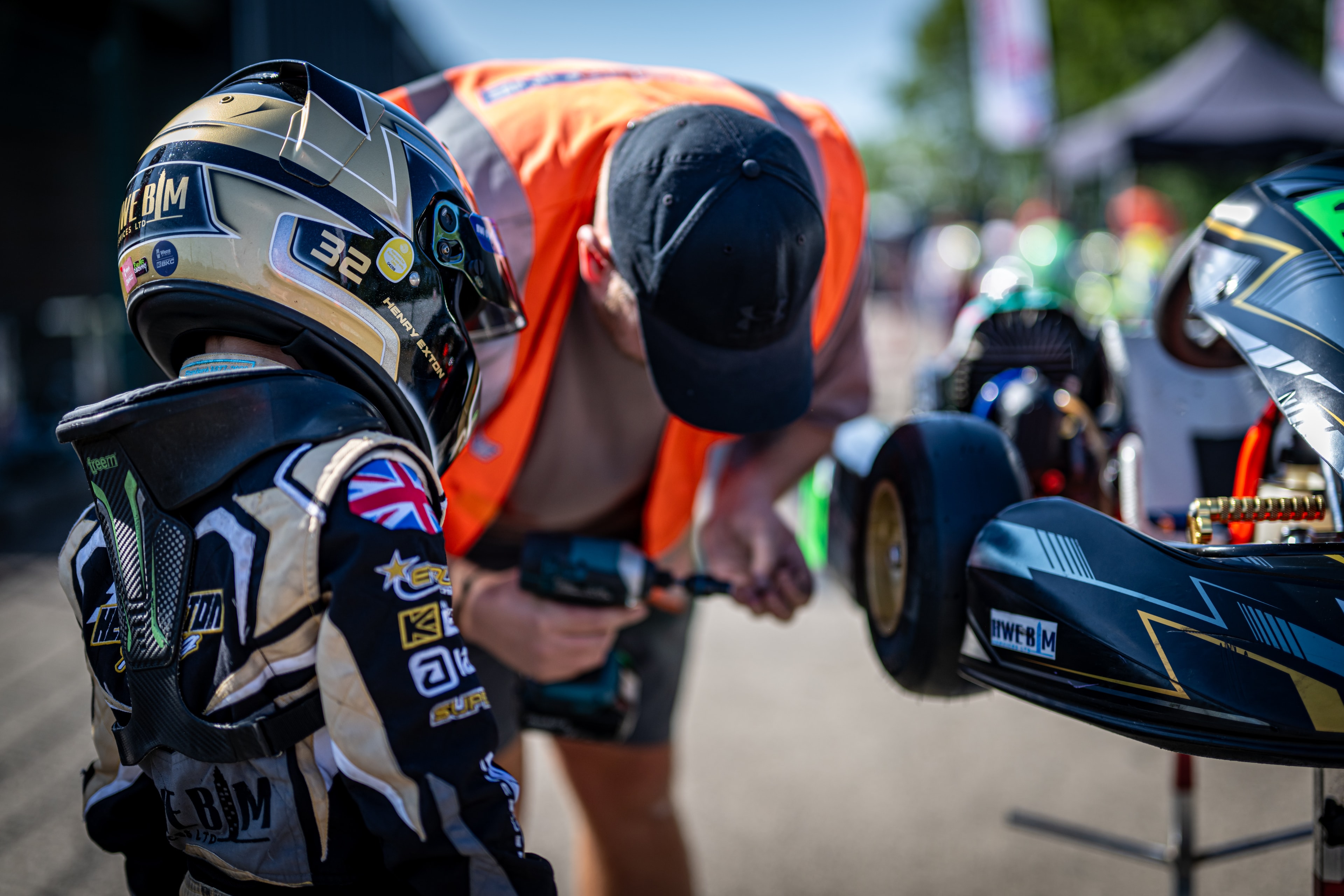 Henry Exton kart number 32 with mechanic in parc ferme at Whilton Mill